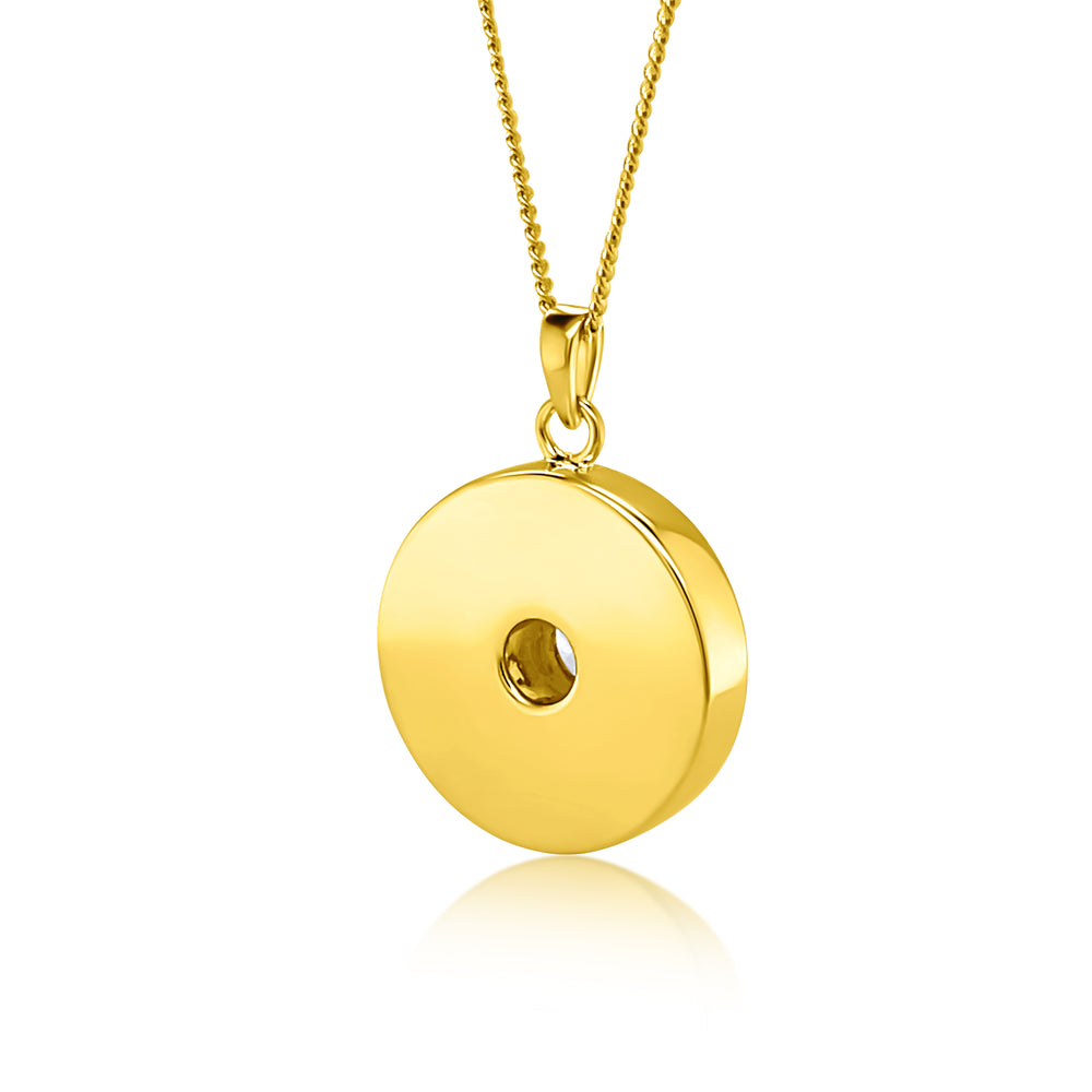 A polished yellow gold pendant necklace featuring a flat, circular disc with a central hole, suspended from a matching gold chain against a clean white background.
