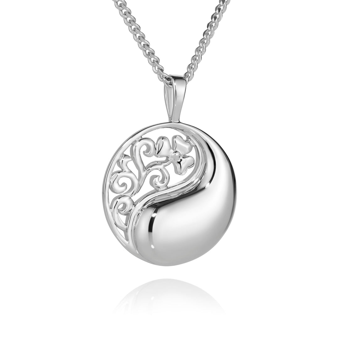 Silver necklace with a round pendant on a white background