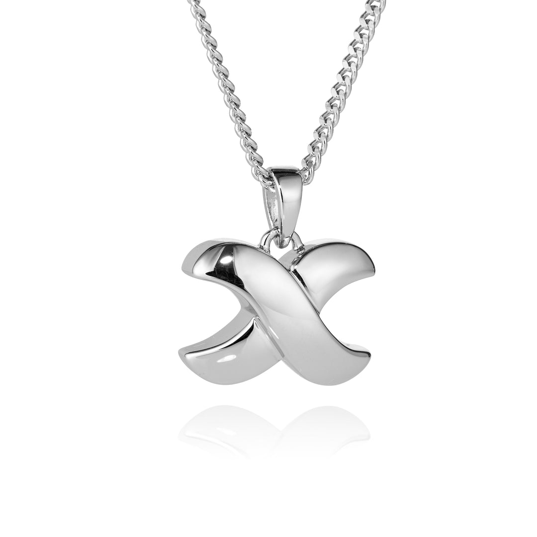 A polished silver pendant necklace featuring a stylized, interlocking cursive 'X' design on a matching silver chain, set against a clean white background with a soft reflection below.