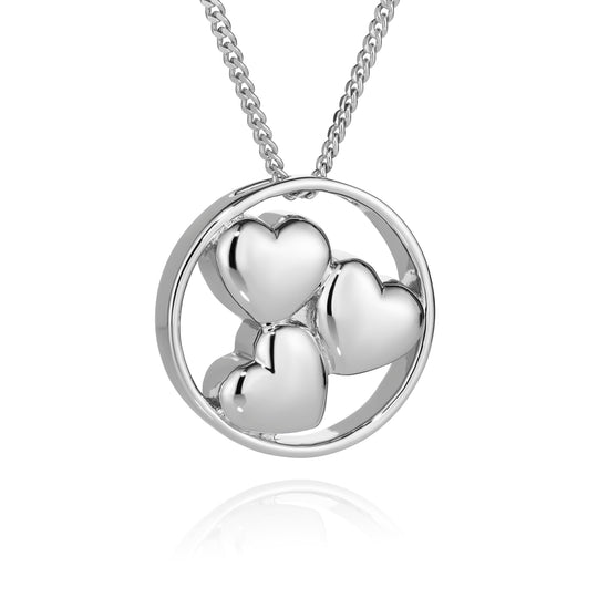 Silver necklace with a circular pendant featuring three heart shapes on a white background