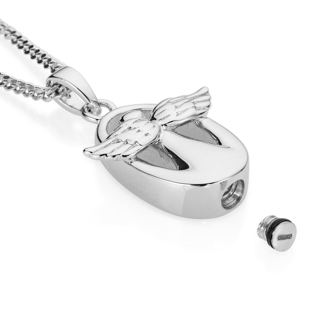 Silver pendant with angel wings on a white background