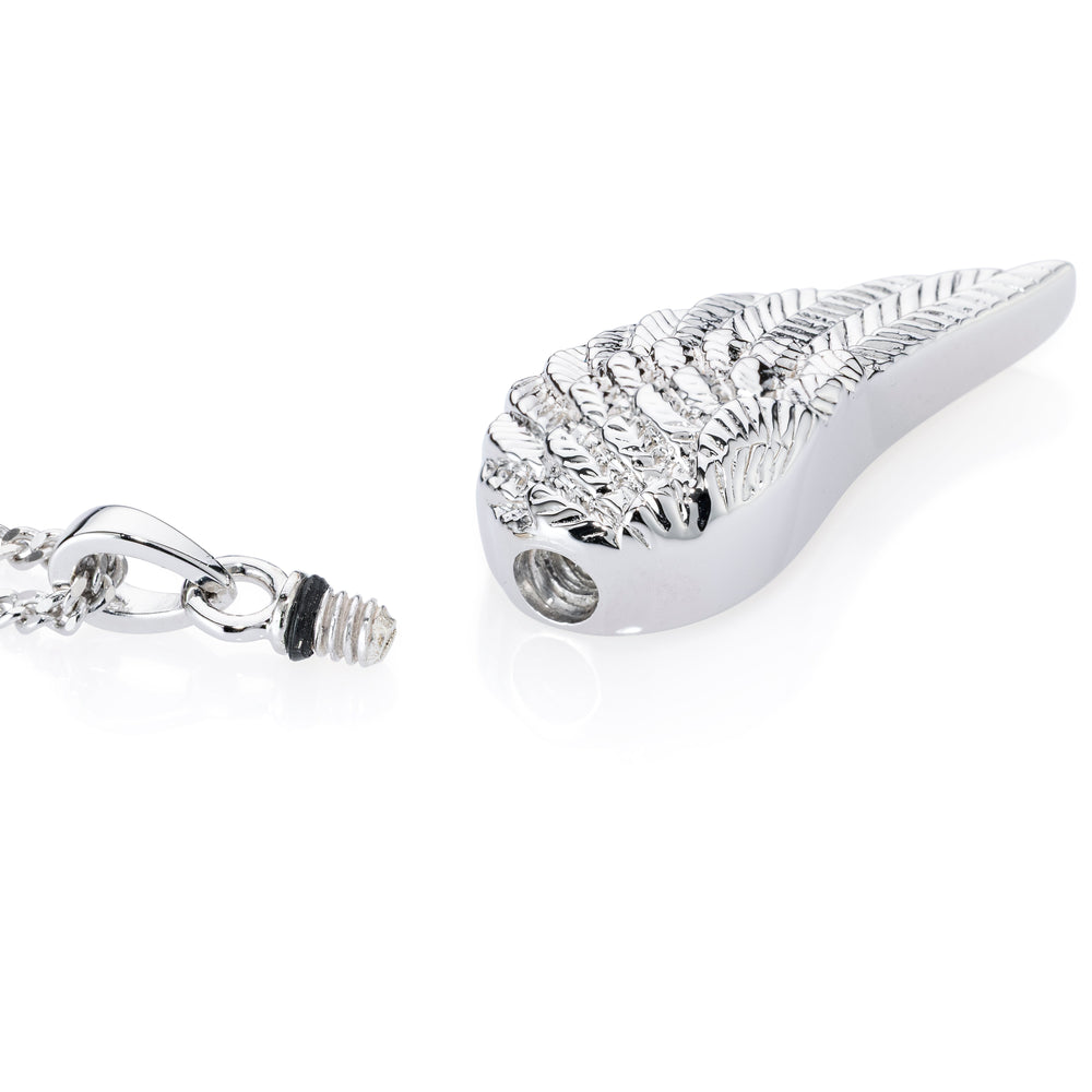 A silver-toned metal cremation urn pendant shaped like a stylized wing with a textured surface, shown alongside its chain and threaded clasp on a clean white background.