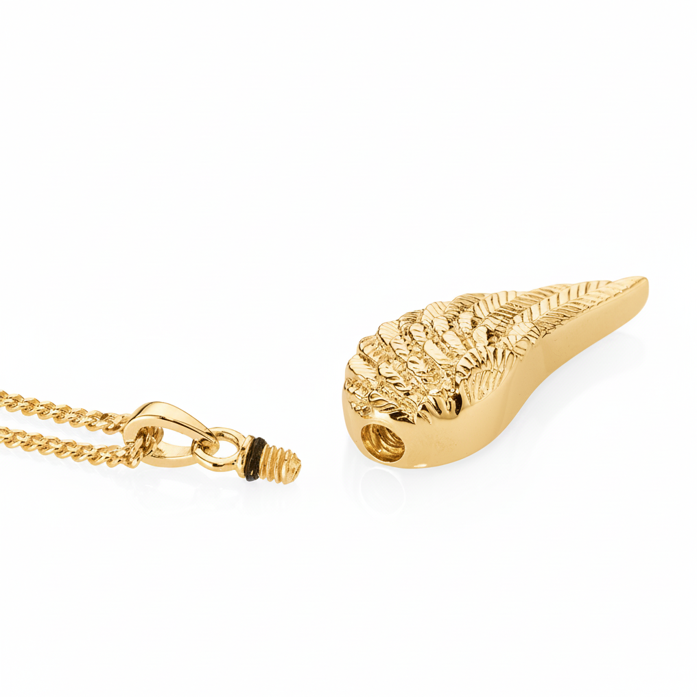 Gold leaf-shaped pendant on a chain against a white background