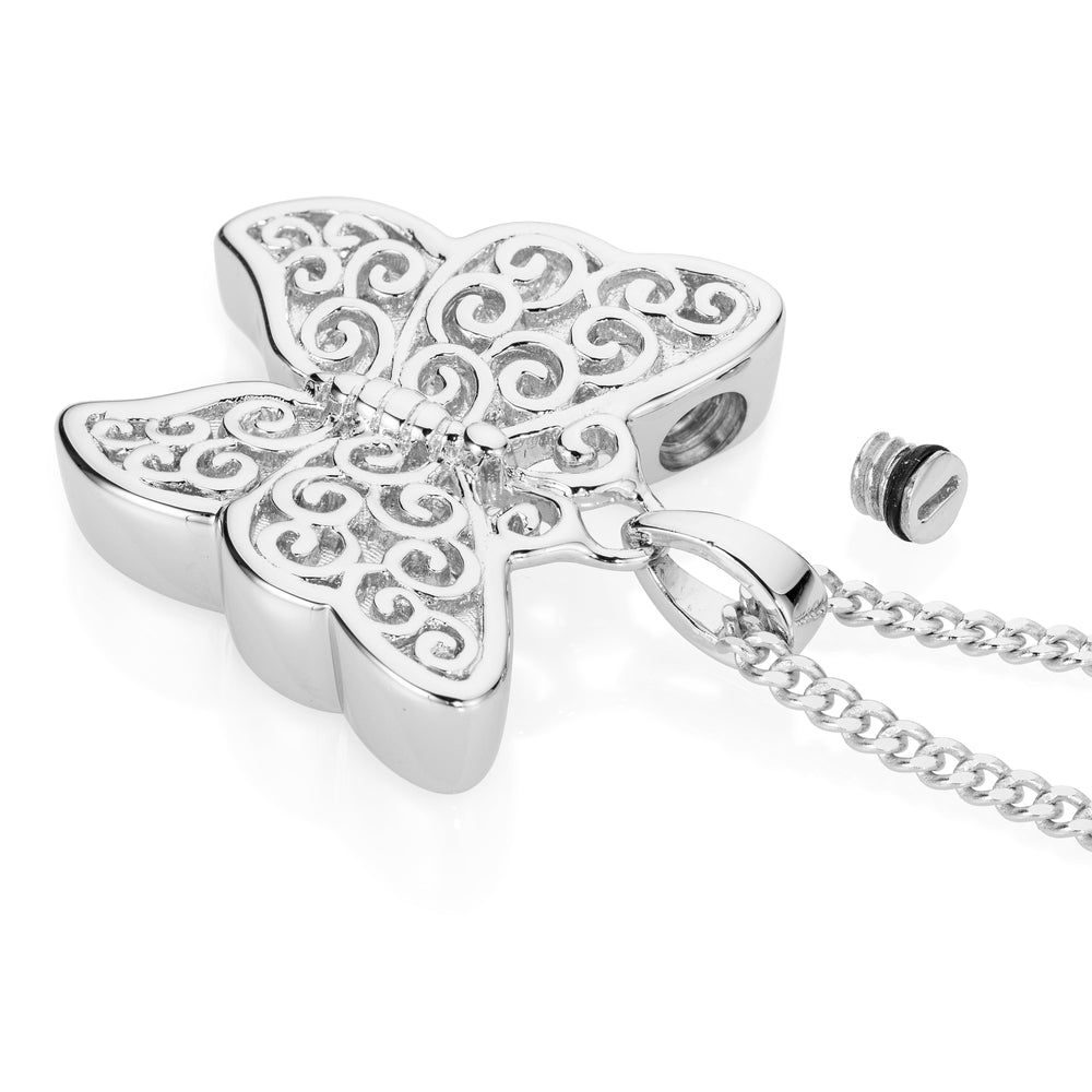 A silver butterfly-shaped pendant necklace with an intricate filigree scroll pattern on the wings, shown on a white background with its matching chain and a small screw cap.