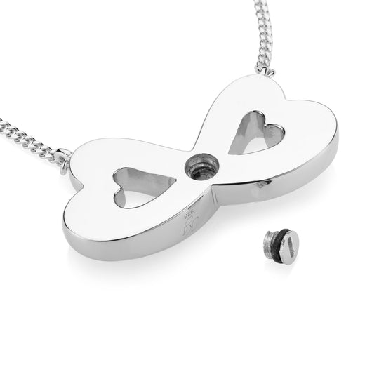 A silver infinity-shaped pendant necklace with two heart cutouts and a small screw fastener, shown on a white background with a small matching screw accessory nearby.