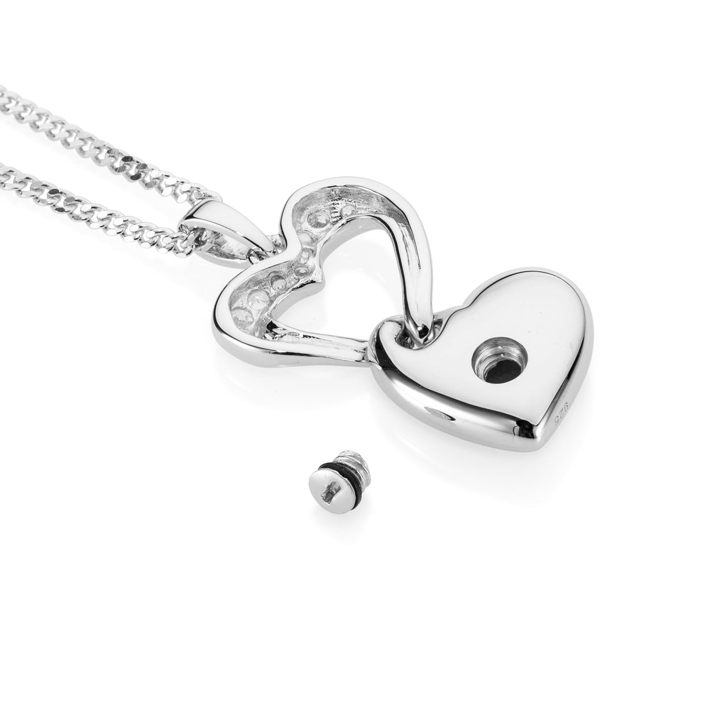 Silver heart-shaped pendant on a chain against a white background