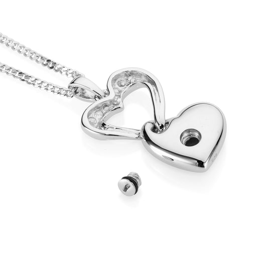 Silver heart-shaped pendant on a chain against a white background