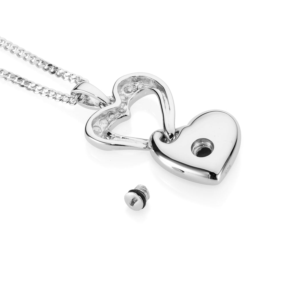 Silver heart-shaped pendant on a chain against a white background