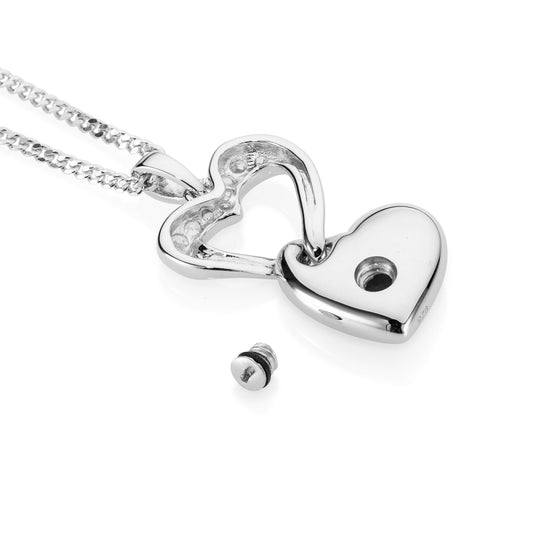 Silver heart-shaped pendant on a chain against a white background