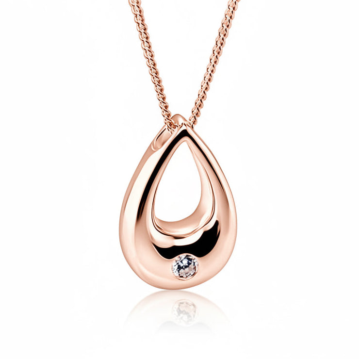 A rose gold teardrop pendant necklace with a small clear gemstone accent, shown on a white background with a soft reflection below.