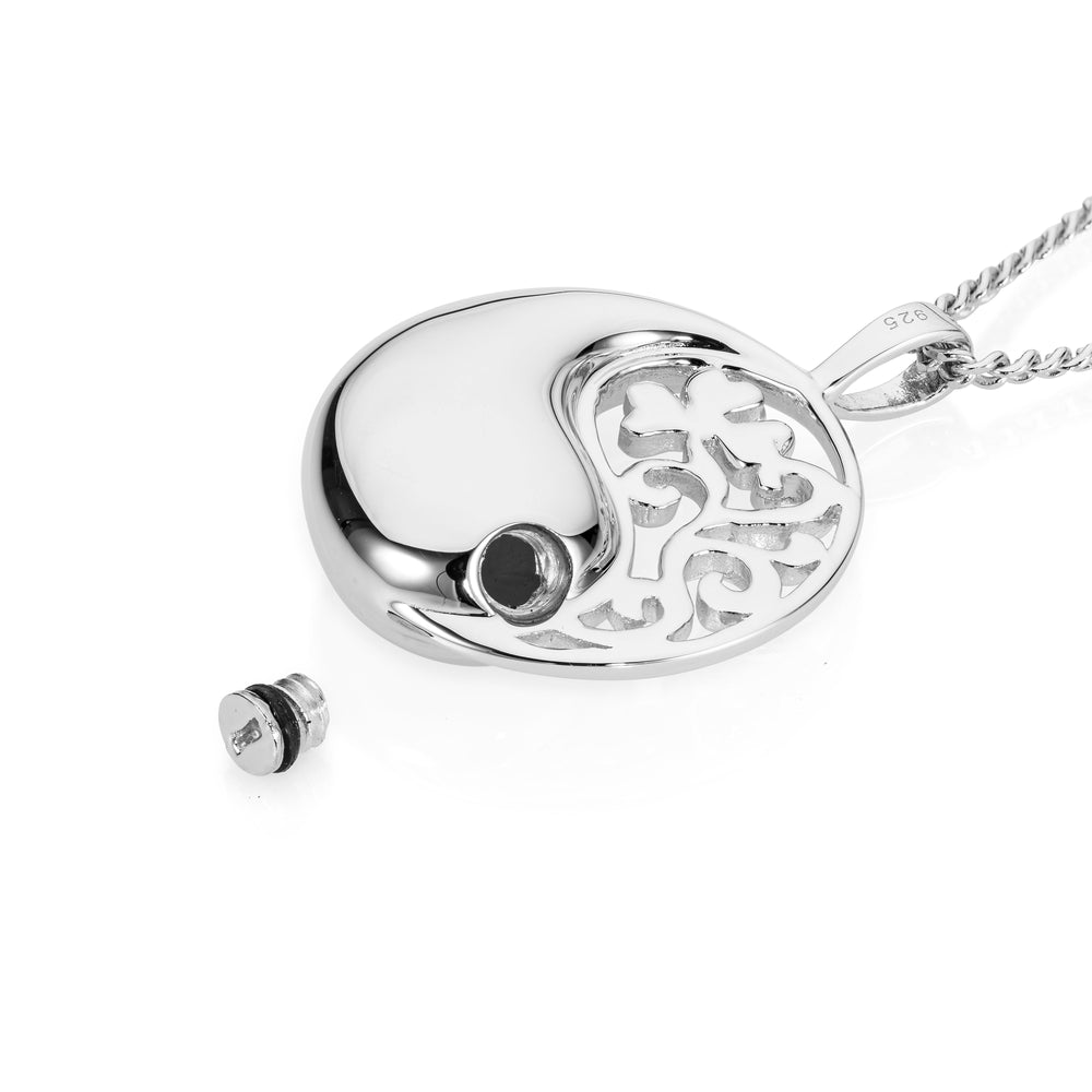 Silver yin yang pendant with chain on a white background