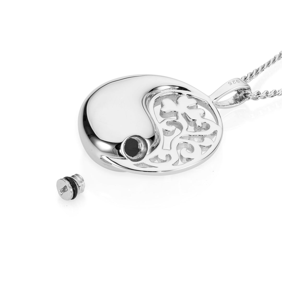 Silver yin yang pendant with chain on a white background