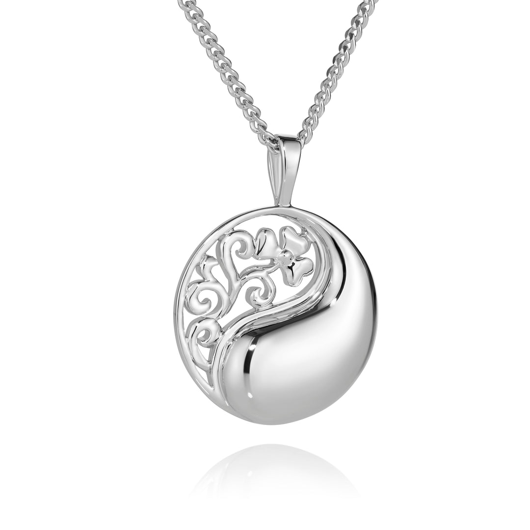 Silver necklace with a round pendant on a white background