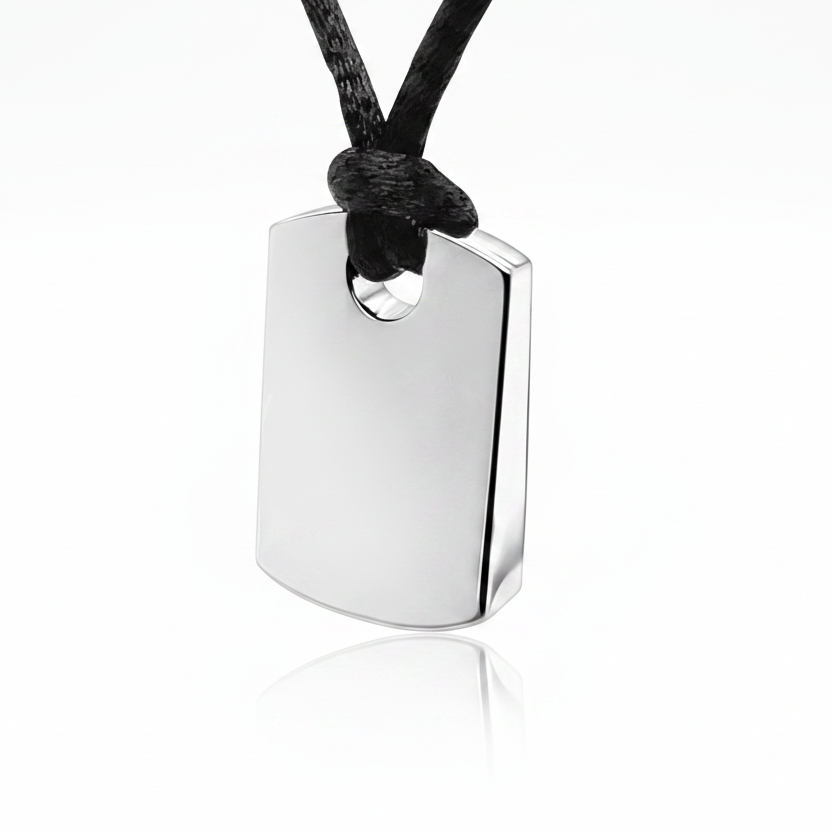 A polished silver military-style dog tag pendant on a black cord, shown against a clean white background with a soft reflection below.