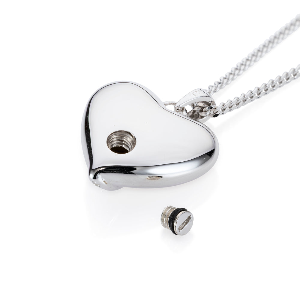 A silver heart-shaped pendant necklace on a matching chain, shown on a clean white background. The pendant has a small screw hole and a separate screw cap placed below it.
