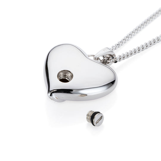 A silver heart-shaped pendant necklace on a matching chain, shown on a clean white background. The pendant has a small screw hole and a separate screw cap placed below it.