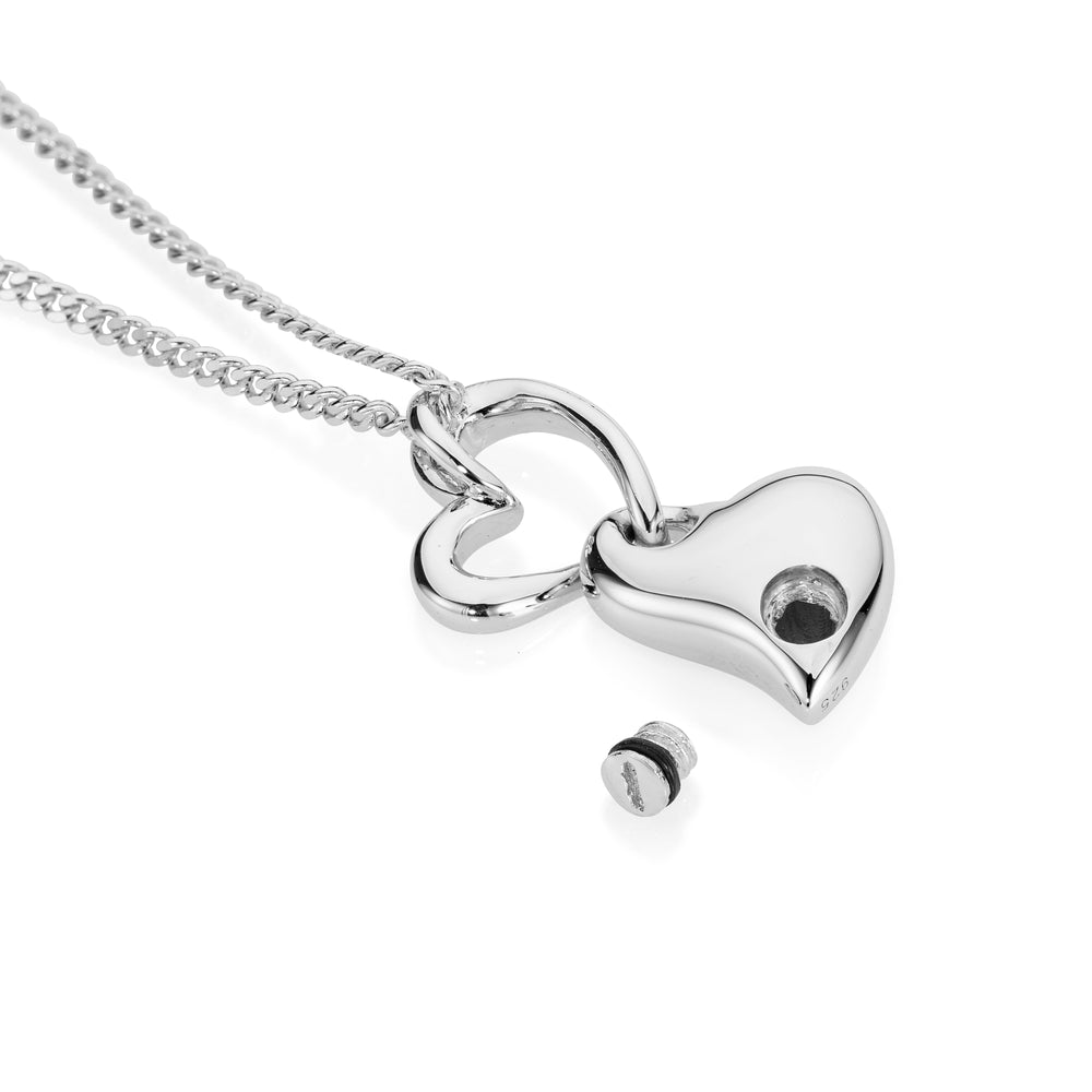 Silver heart-shaped pendant on a chain against a white background