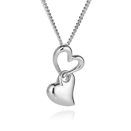 Silver heart-shaped pendant on a chain against a white background